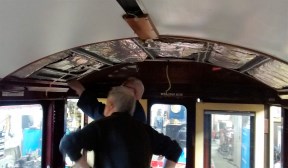 Image:- 2 people working on ceiling of carriage 119