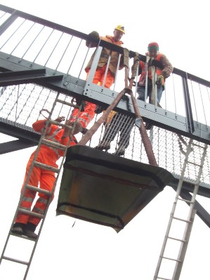 Image:_ Smokeplate being lifted into position