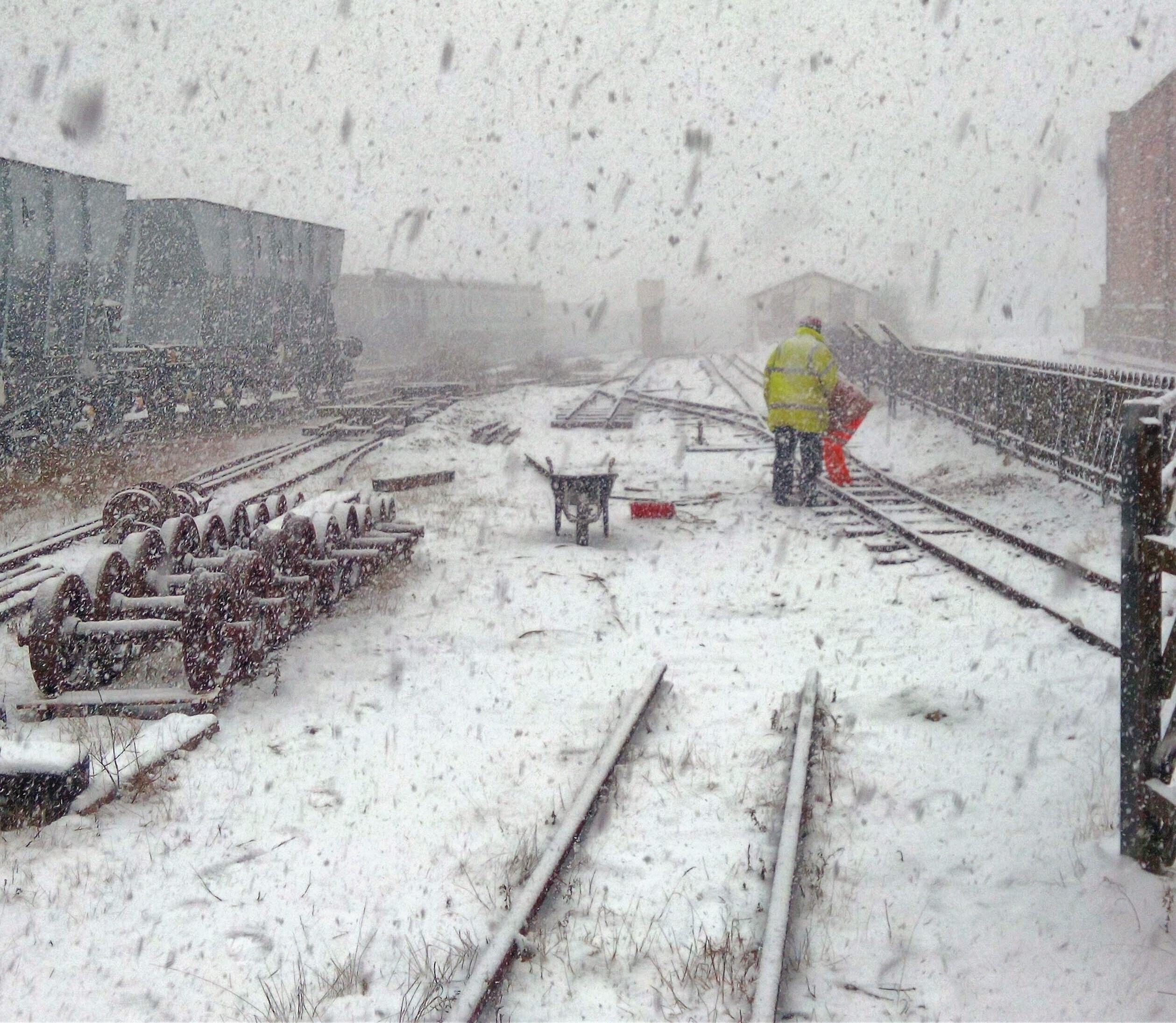 Image:- Volunteers working on snow covered track